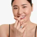 A 14K White Gold Princess Cut Diamond Ring with Sapphires, featuring four Marquise Blue Sapphires (0.62 CT min) set as flower petals, accented by a 0.18 CT Princess Cut Diamond and 0.28 CTW Round Diamonds.