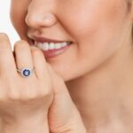 A 14K White Gold Princess Cut Diamond Ring with Sapphires, featuring four Marquise Blue Sapphires (0.62 CT min) set as flower petals, accented by a 0.18 CT Princess Cut Diamond and 0.28 CTW Round Diamonds.