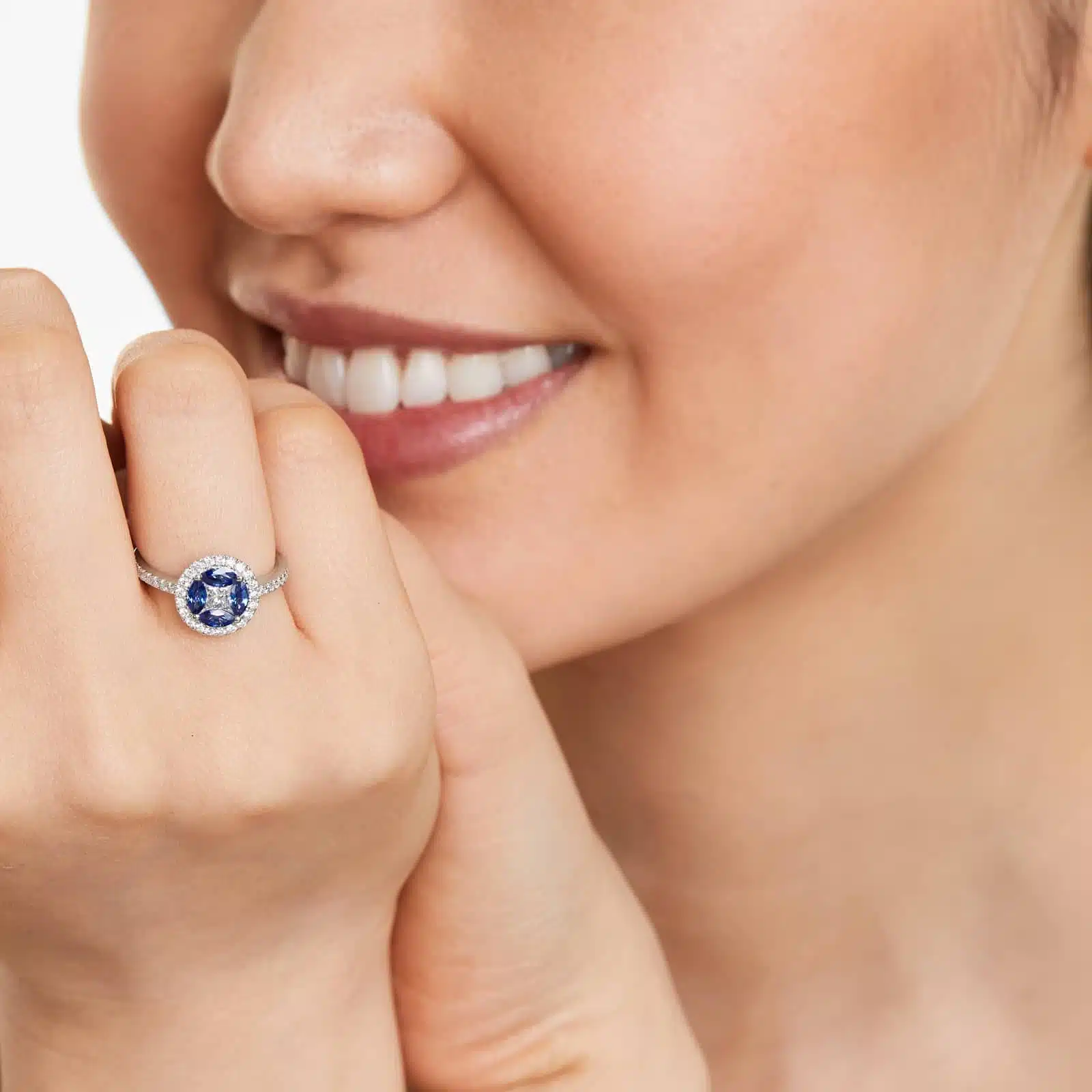 A 14K White Gold Princess Cut Diamond Ring with Sapphires, featuring four Marquise Blue Sapphires (0.62 CT min) set as flower petals, accented by a 0.18 CT Princess Cut Diamond and 0.28 CTW Round Diamonds.