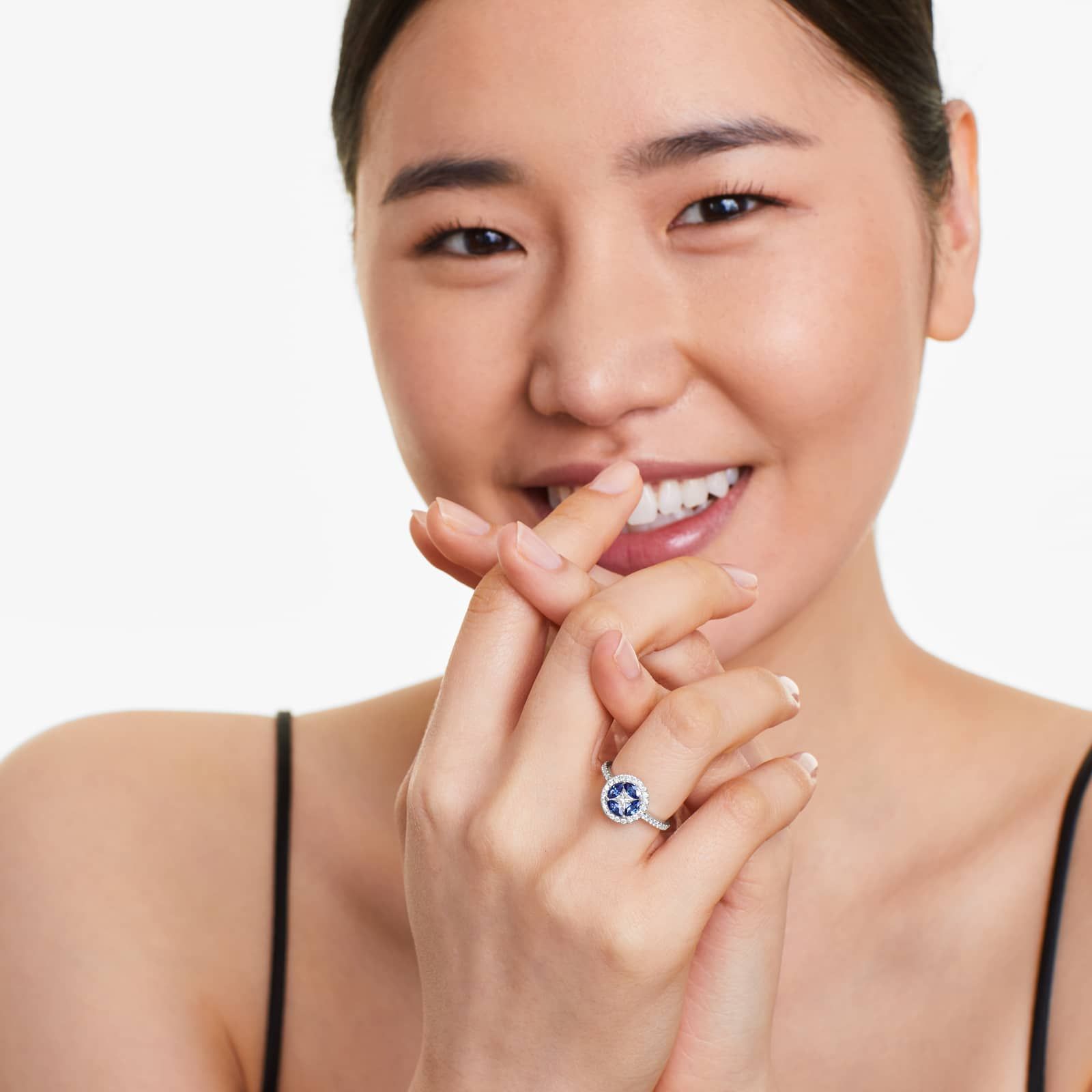 marquise-sapphire-princess-cut-diamond-ring-with-sapphires-14k-white-gold model view A 14K White Gold Princess Cut Diamond Ring with Sapphires, featuring four Marquise Blue Sapphires (0.62 CT min) set as flower petals, accented by a 0.18 CT Princess Cut Diamond and 0.28 CTW Round Diamonds.