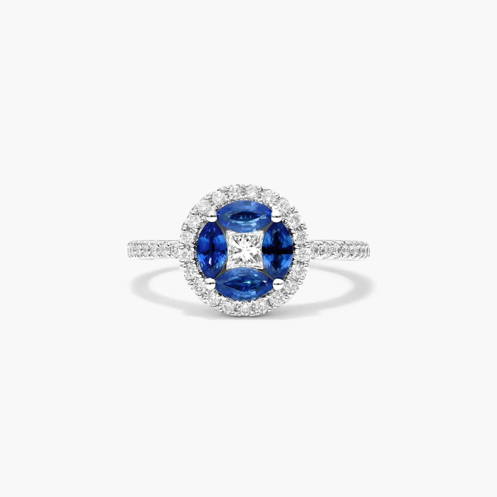 A 14K White Gold Princess Cut Diamond Ring with Sapphires, featuring four Marquise Blue Sapphires (0.62 CT min) set as flower petals, accented by a 0.18 CT Princess Cut Diamond and 0.28 CTW Round Diamonds.