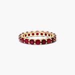 A Milgrain Embellished Ruby Eternity Ruby Wedding Rings For Women band (3.00mm) in 14K Yellow Gold with 2.25 CTW Round Rubies and diamond accents.
