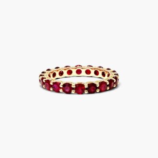 A Milgrain Embellished Ruby Eternity Ruby Wedding Rings For Women band (3.00mm) in 14K Yellow Gold with 2.25 CTW Round Rubies and diamond accents.