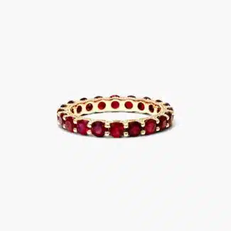 A Milgrain Embellished Ruby Eternity Ruby Wedding Rings For Women band (3.00mm) in 14K Yellow Gold with 2.25 CTW Round Rubies and diamond accents.