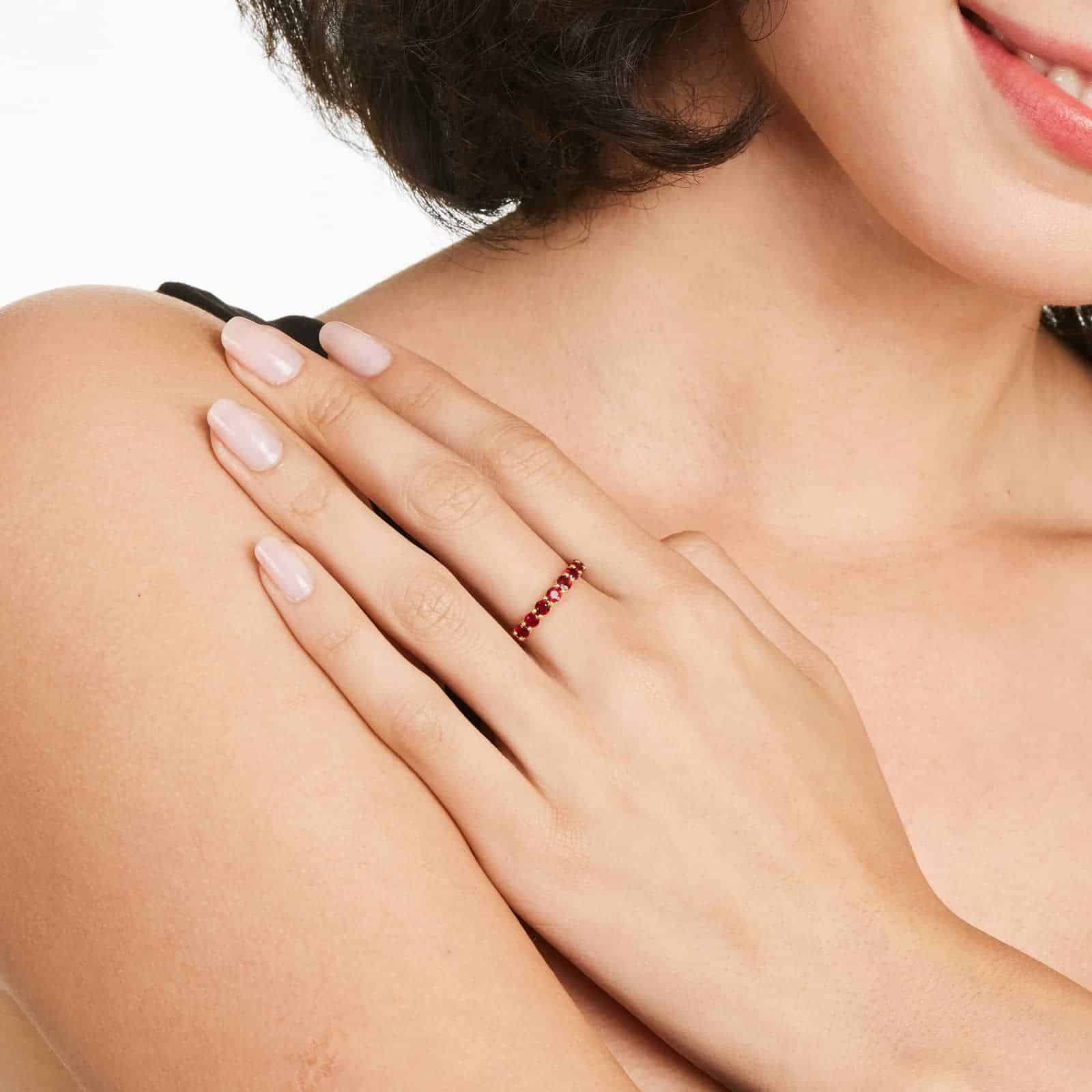 A Milgrain Embellished Ruby Eternity Ruby Wedding Rings For Women band (3.00mm) in 14K Yellow Gold with 2.25 CTW Round Rubies and diamond accents.