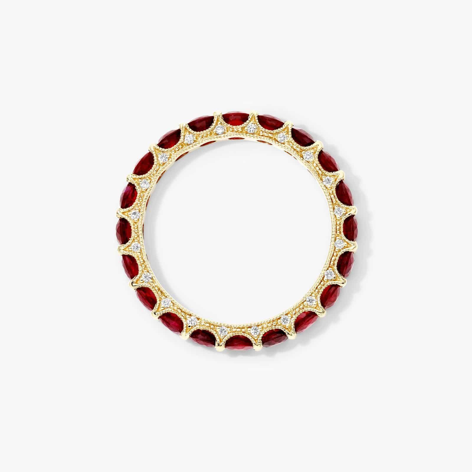 A Milgrain Embellished Ruby Eternity Ruby Wedding Rings For Women band (3.00mm) in 14K Yellow Gold with 2.25 CTW Round Rubies and diamond accents.