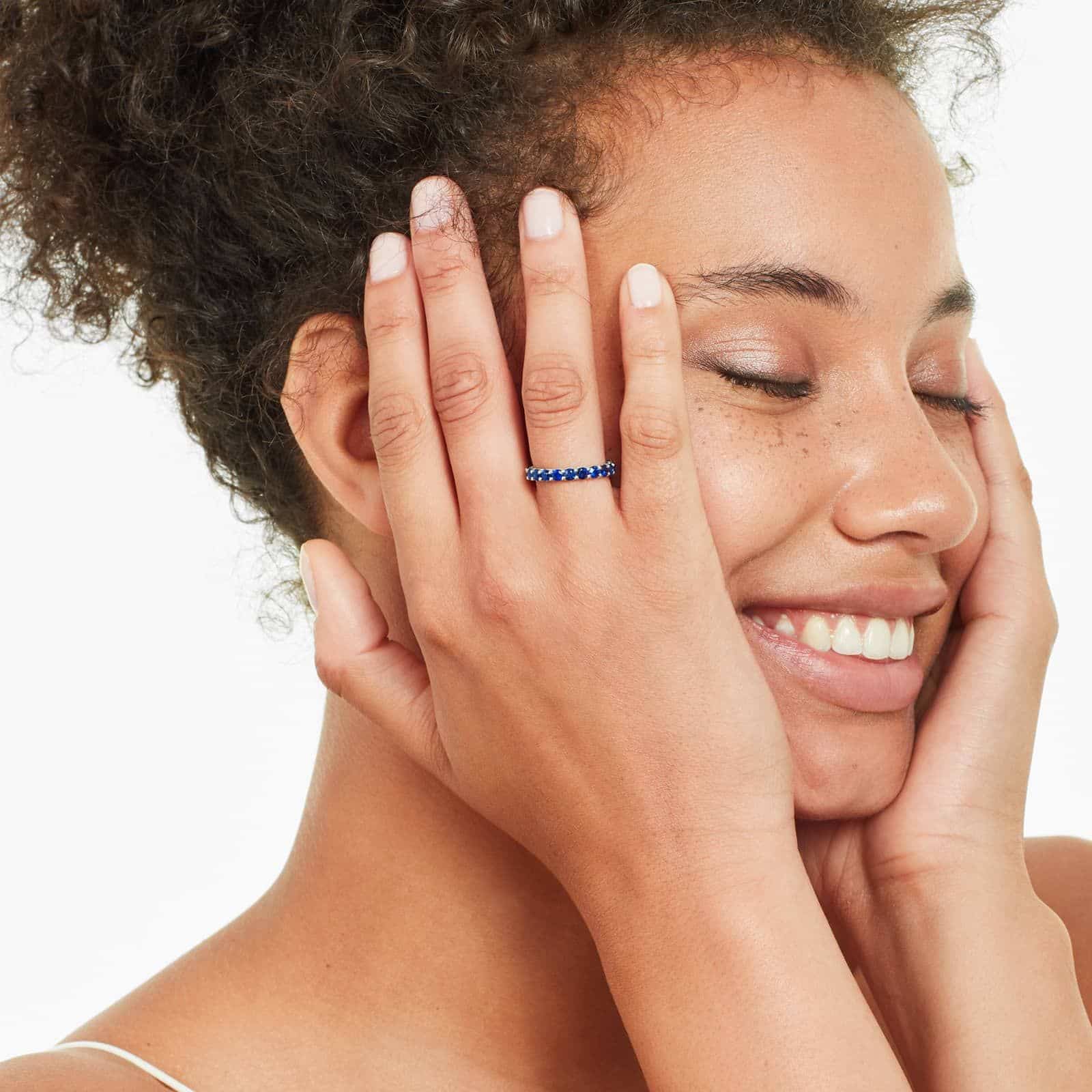 A 14K White Gold Blue Sapphire and Diamond Wedding Ring Sets component: a 3.00 mm Milgrain Embellished Eternity Band with 2.25 Carat minimum Round Blue Sapphires and 0.11 CTW diamond accents.