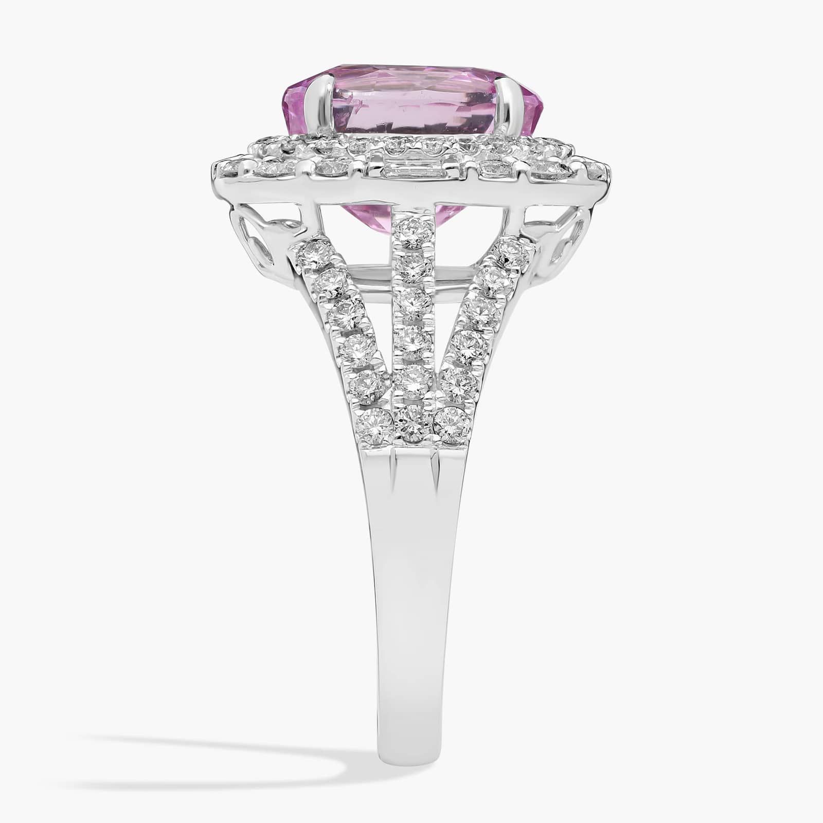 oval-halo-pink-sapphire-diamond-ring-18k-5-04ct side view 2 An 18K White Gold Pink Sapphire and Diamond Ring, designed as a Cocktail Ring, featuring a 5.04 Carat Oval Pink Sapphire center stone surrounded by a halo of Round and Baguette diamonds (0.94 CTW total).