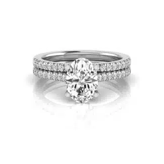 An IGI Certified Stacked Wedding Bands With Engagement Ring set in 14K White Gold featuring a 2.00 CT Oval Lab-Grown Diamond and a 0.50 CTW stackable wedding band.