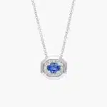 14K white gold blue sapphire pendant necklace featuring a 0.48 carat oval blue sapphire center stone and a pavé diamond halo on an 18-inch rolo chain.