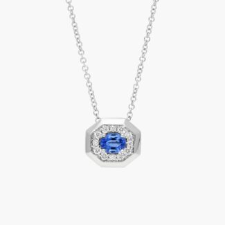 14K white gold blue sapphire pendant necklace featuring a 0.48 carat oval blue sapphire center stone and a pavé diamond halo on an 18-inch rolo chain.