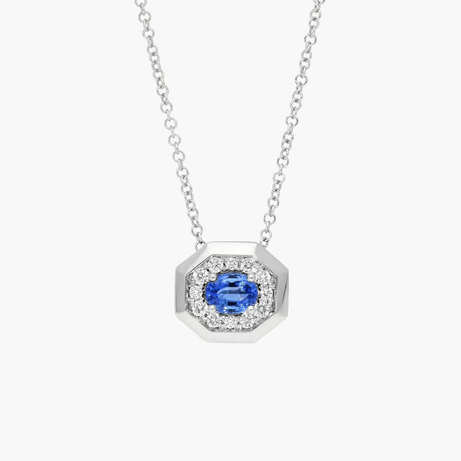 pave-diamond-and-oval-blue-sapphire-pendant-necklace-14k-white-gold 14K white gold blue sapphire pendant necklace featuring a 0.48 carat oval blue sapphire center stone and a pavé diamond halo on an 18-inch rolo chain.