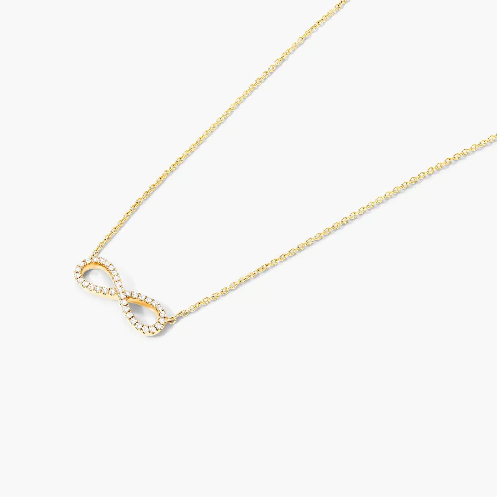14K yellow gold infinity necklaces valentine's day jewelry for her featuring a diamond pavé infinity symbol on a 16-inch cable chain.