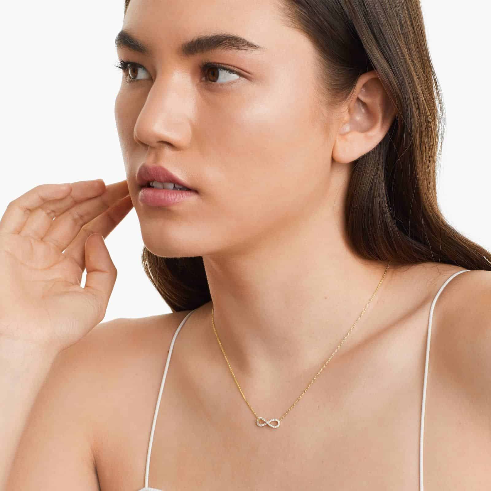 14K yellow gold infinity necklaces valentine's day jewelry for her featuring a diamond pavé infinity symbol on a 16-inch cable chain.