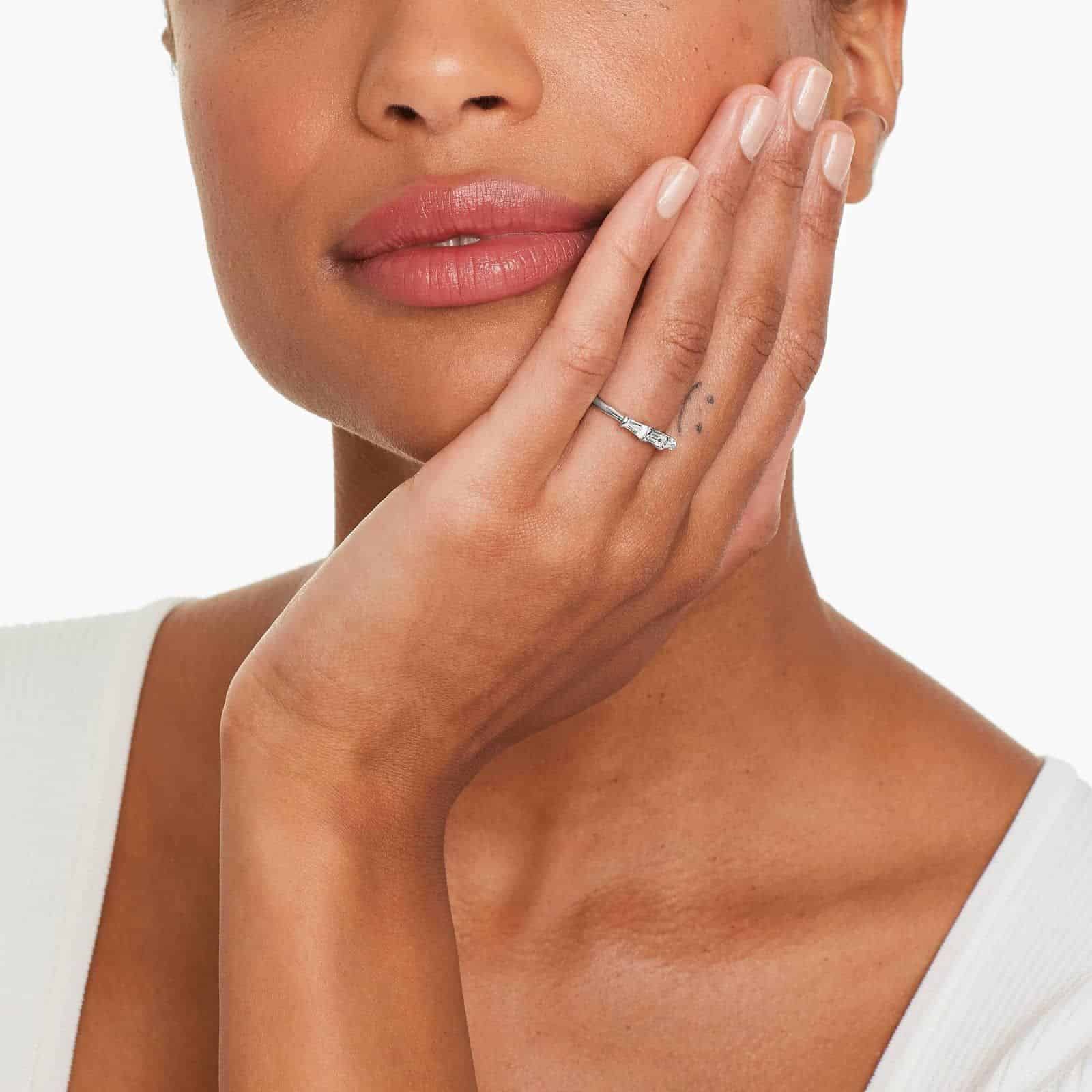 platinum-diamond-tapered-baguette-wedding-band-0-33ctw model view A 2.00 mm Platinum Tapered Baguette Wedding Band featuring three Natural Tapered Baguette Diamonds totaling 0.33 CTW.