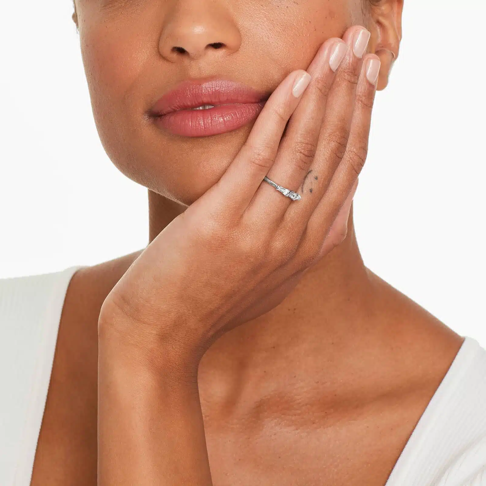 A 2.00 mm Platinum Tapered Baguette Wedding Band featuring three Natural Tapered Baguette Diamonds totaling 0.33 CTW.