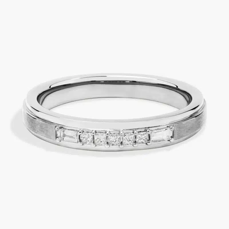 A 3.60 mm wide Platinum Mens Wedding Bands With Baguettes featuring an alternating pattern of Baguette and Princess Cut natural diamonds (1/5 CTW).