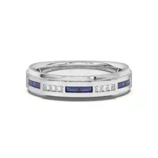 An 18K White Gold Women's Baguette Wedding Band featuring an alternating channel-set pattern of Baguette Blue Sapphires and Round Diamonds (0.06 CTW). The band tapers in width.