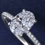Platinum oval micropavé engagement rings under $2,500 featuring a 1 carat oval lab grown diamond and 22 natural diamond accents on a 1.70mm shank.