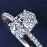 Platinum oval micropavé engagement rings under $2,500 featuring a 1 carat oval lab grown diamond and 22 natural diamond accents on a 1.70mm shank.