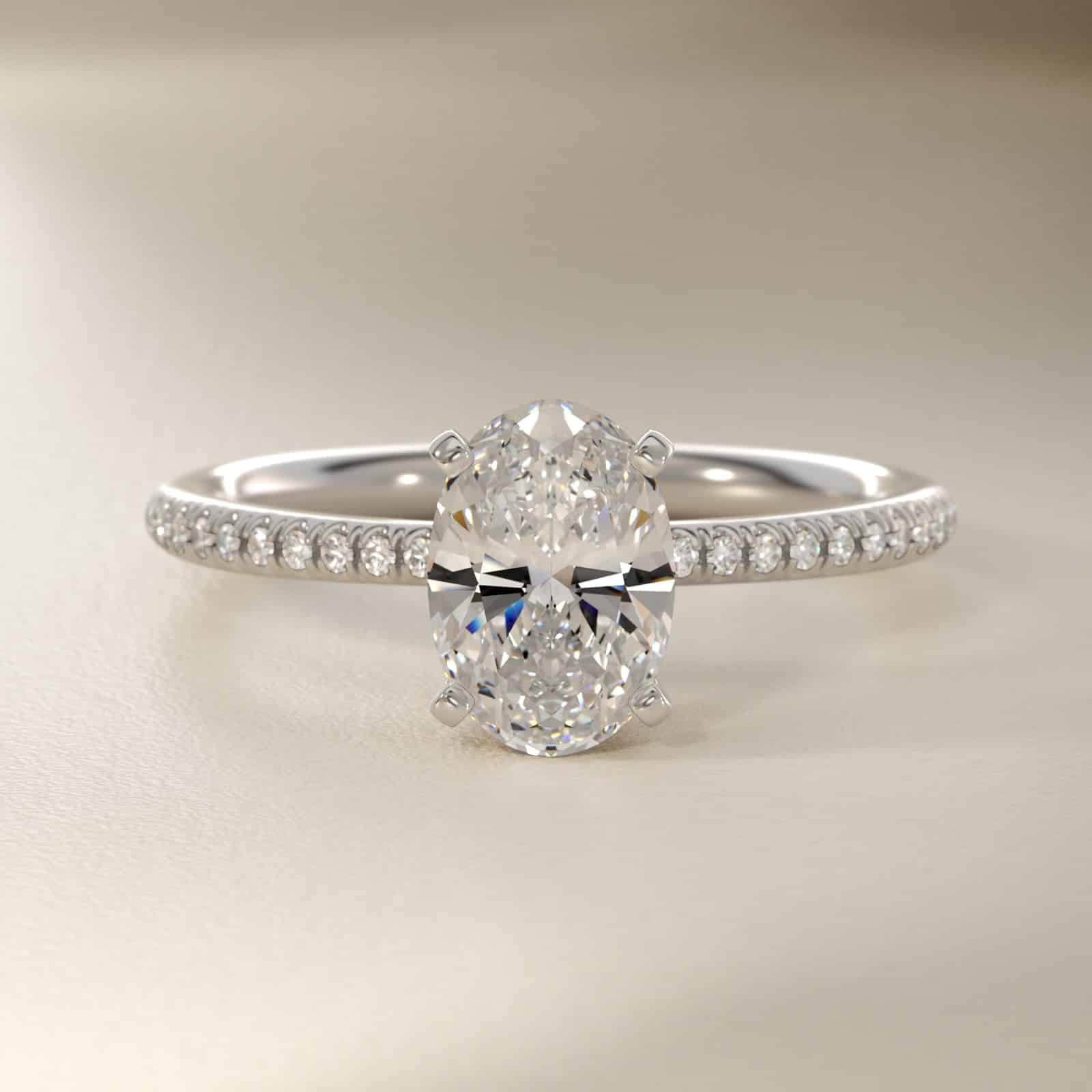 Platinum oval micropavé engagement rings under $2,500 featuring a 1 carat oval lab grown diamond and 22 natural diamond accents on a 1.70mm shank.