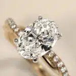 14K yellow gold oval twist engagement rings under $2,500 featuring a 1 carat oval lab grown diamond and 20 natural diamond accents on a 2.80mm shank.