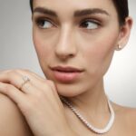 14K yellow gold oval twist engagement rings under $2,500 featuring a 1 carat oval lab grown diamond and 20 natural diamond accents on a 2.80mm shank.