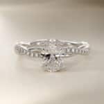 Platinum oval twist engagement rings under $2,500 featuring a 1 carat oval lab grown diamond and 20 natural diamond accents on a 2.80mm shank.