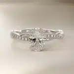 Platinum oval twist engagement rings under $2,500 featuring a 1 carat oval lab grown diamond and 20 natural diamond accents on a 2.80mm shank.