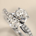 Platinum oval twist engagement rings under $2,500 featuring a 1 carat oval lab grown diamond and 20 natural diamond accents on a 2.80mm shank.