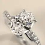 Platinum oval twist engagement rings under $2,500 featuring a 1 carat oval lab grown diamond and 20 natural diamond accents on a 2.80mm shank.