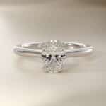 Platinum oval solitaire engagement rings under $2,500 featuring a 1.5 carat oval lab-grown diamond on a 1.80mm petite band.