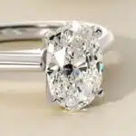 Platinum oval solitaire engagement rings under $2,500 featuring a 1.5 carat oval lab-grown diamond on a 1.80mm petite band.