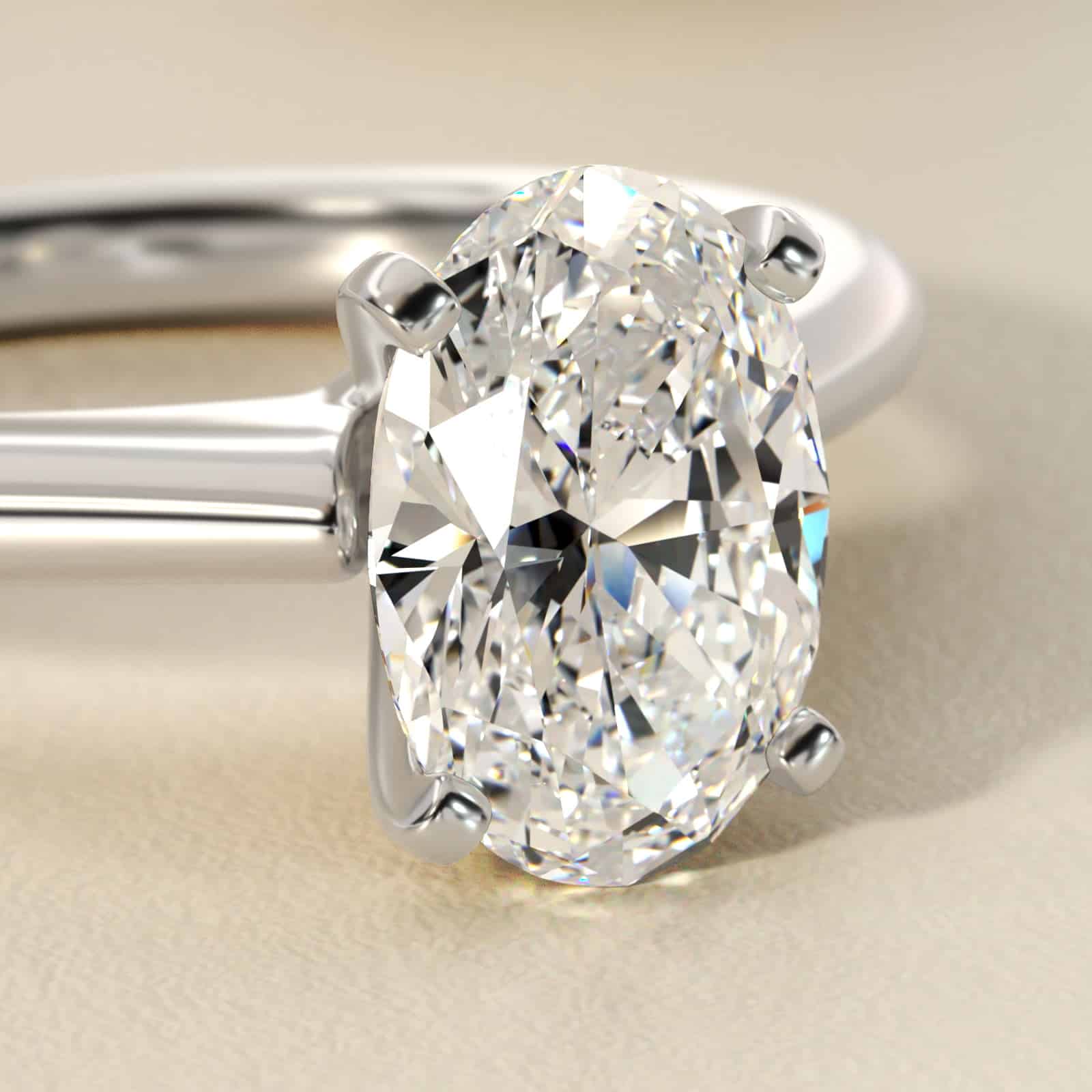 Platinum oval solitaire engagement rings under $2,500 featuring a 1.5 carat oval lab-grown diamond on a 1.80mm petite band.