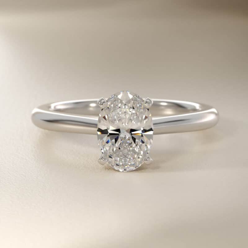 Platinum oval solitaire engagement rings under $2,500 featuring a 1.5 carat oval lab-grown diamond on a 1.80mm petite band.