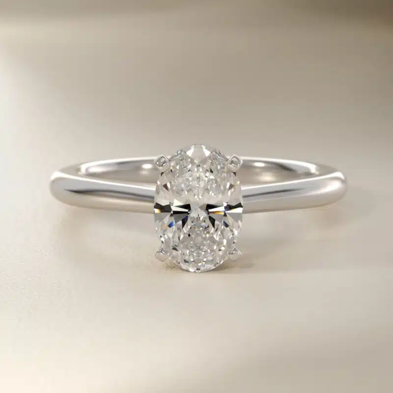 Platinum oval solitaire engagement rings under $2,500 featuring a 1.5 carat oval lab-grown diamond on a 1.80mm petite band.