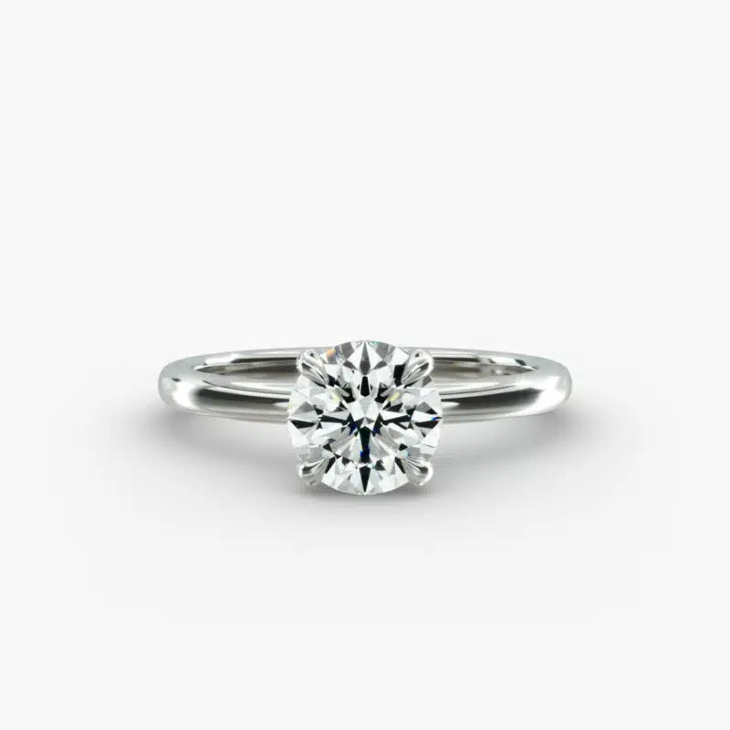 Platinum round solitaire engagement rings under $2,500 featuring a 1 carat round lab grown diamond with claw prongs on a 2.00mm flush-fit band.