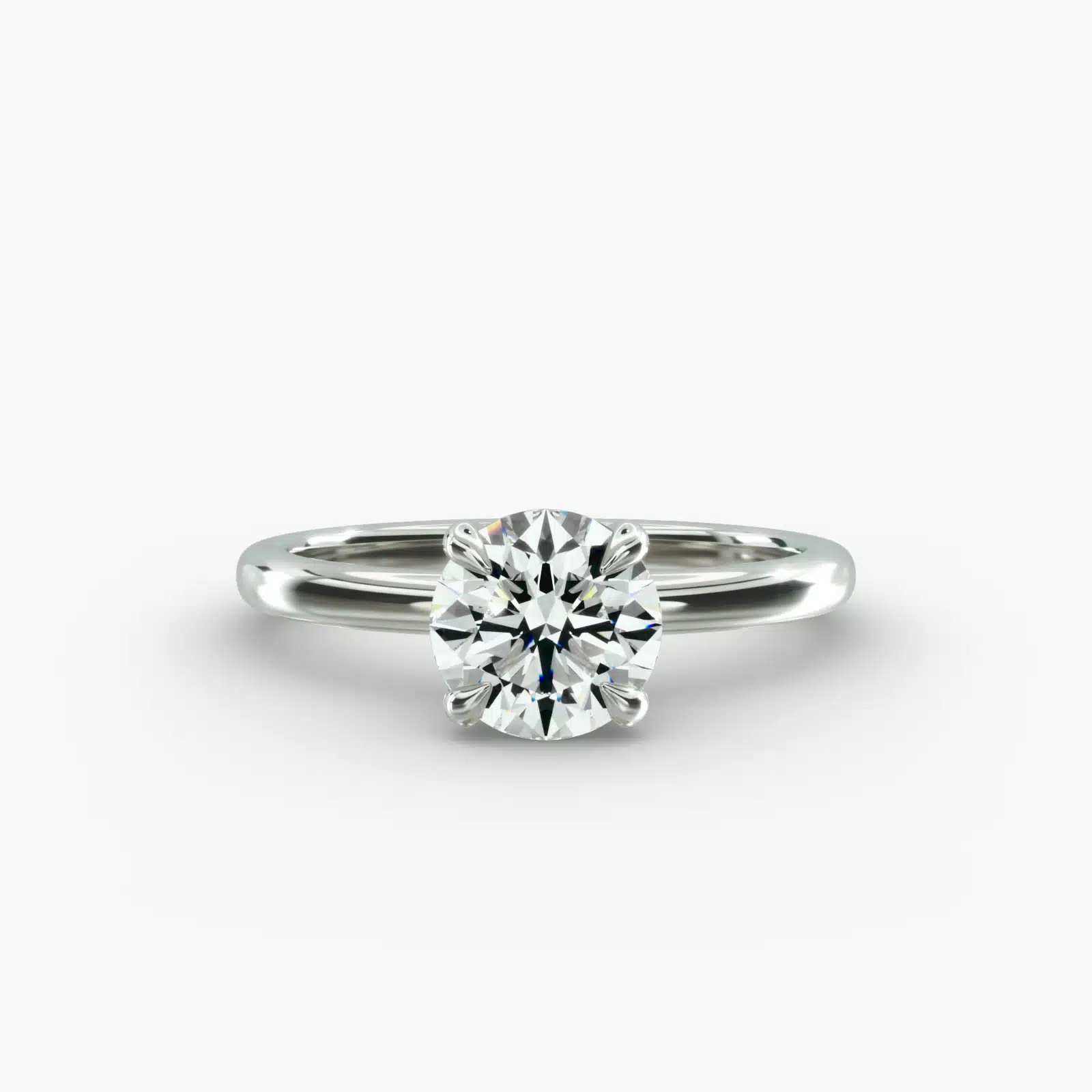 Platinum round solitaire engagement rings under $2,500 featuring a 1 carat round lab grown diamond with claw prongs on a 2.00mm flush-fit band.