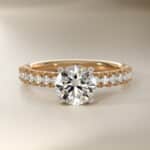 14K yellow gold French pavé engagement rings under $2,500 featuring a 1 carat round lab grown diamond and 16 natural diamond accents.