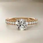 14K yellow gold French pavé engagement rings under $2,500 featuring a 1 carat round lab grown diamond and 16 natural diamond accents.