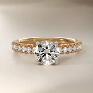 14K yellow gold French pavé engagement rings under $2,500 featuring a 1 carat round lab grown diamond and 16 natural diamond accents.