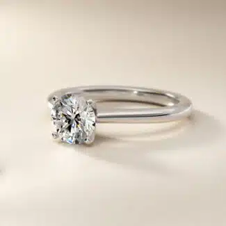 Platinum petite solitaire engagement rings under $2,500 featuring a 1.5 carat colorless VS clarity lab grown diamond on a 1.80mm band.