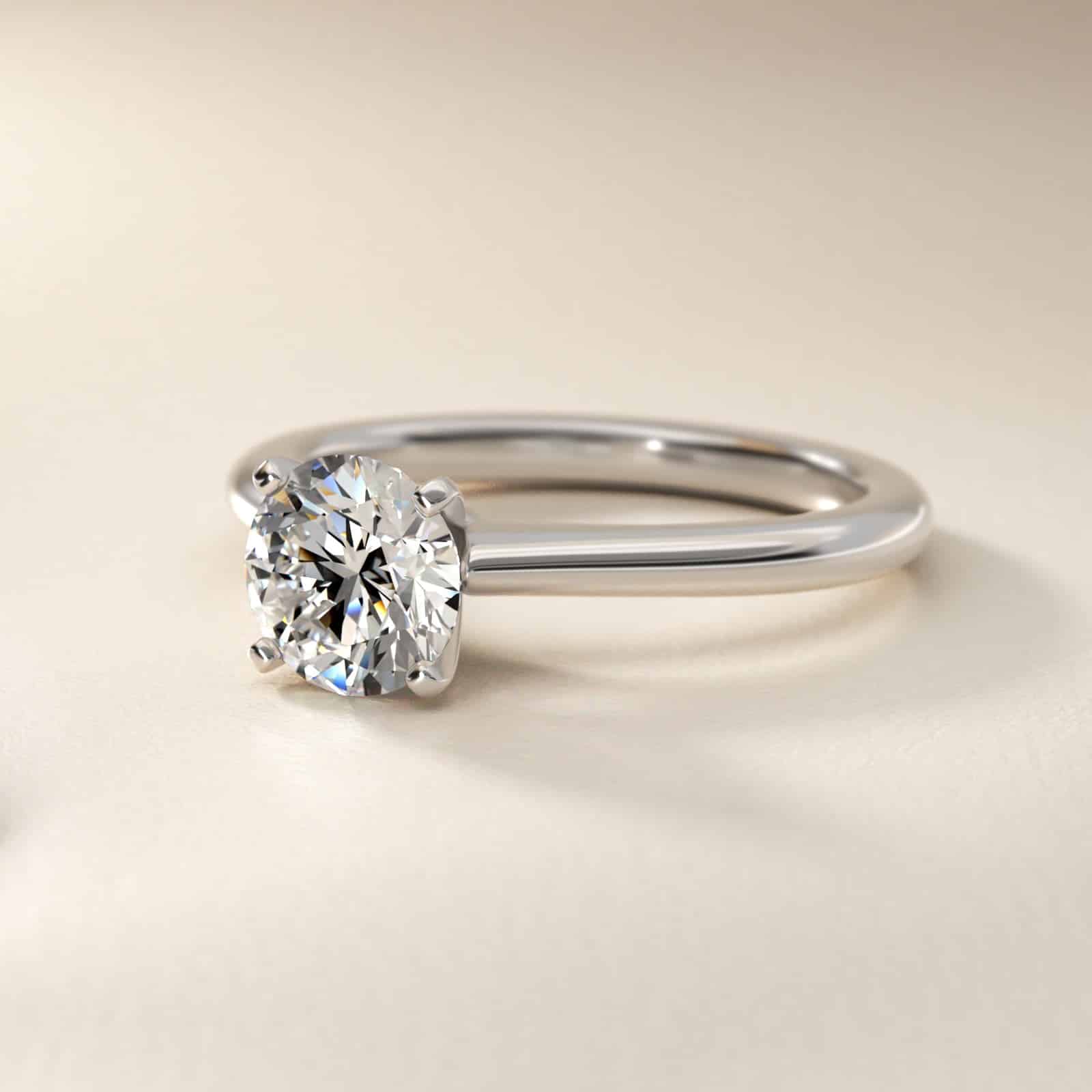 Platinum petite solitaire engagement rings under $2,500 featuring a 1.5 carat colorless VS clarity lab grown diamond on a 1.80mm band.