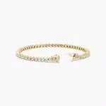 14K yellow gold round lab grown diamond tennis bracelets under $3000 featuring 3 CTW of brilliant-cut diamonds in basket settings.