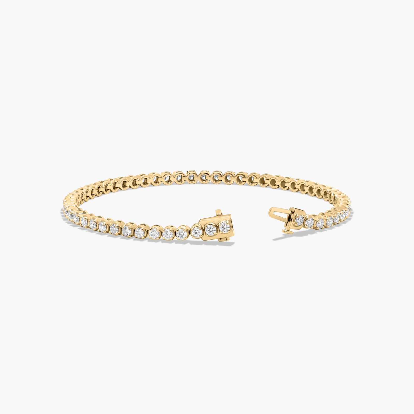 14K yellow gold round lab grown diamond tennis bracelets under $3000 featuring 3 CTW of brilliant-cut diamonds in basket settings.