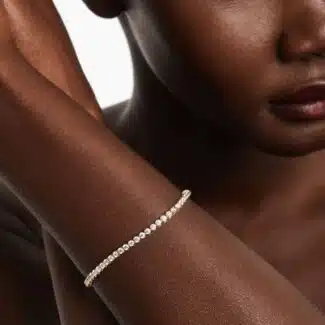 14K yellow gold round lab grown diamond tennis bracelets under $3000 featuring 3 CTW of brilliant-cut diamonds in basket settings.